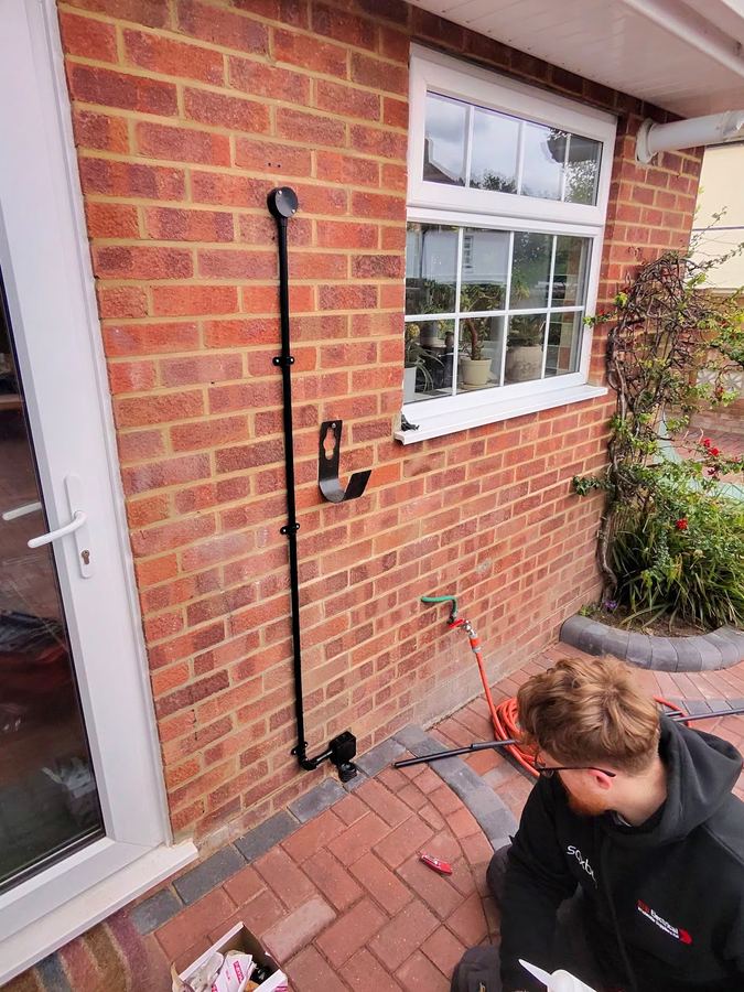 An Electricians Near You electrician running a new cable on a job in Dorset