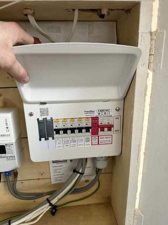 Electrician inspecting a consumer unit during an emergency callout