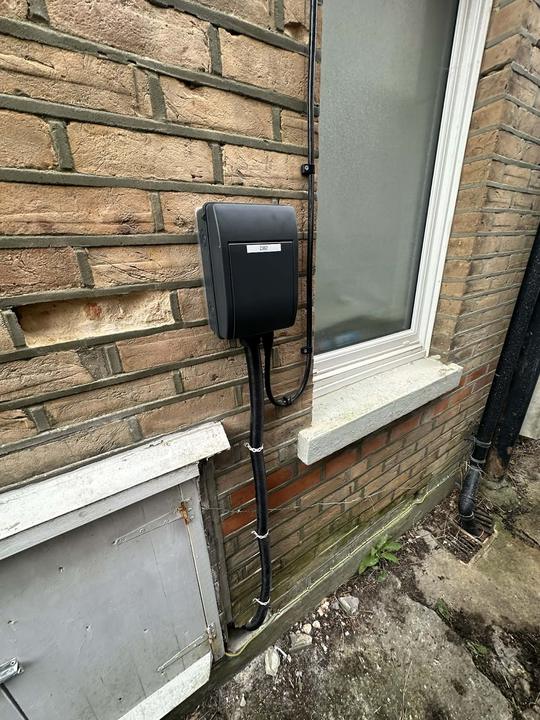 Home EV charger installation on a brick wall